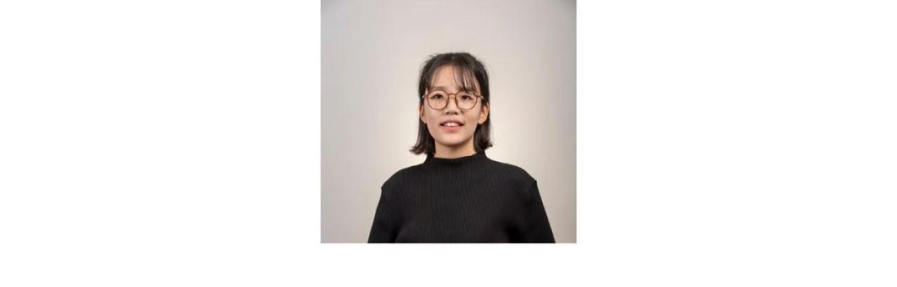 photo of Heerak Choi, a young Korean woman with black hair and glasses wearing a black shirt