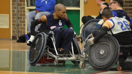 Wheelchair rugby players go for the ball