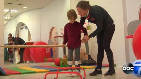 child with CP interacts with therapist at Shirley Ryan AbilityLab