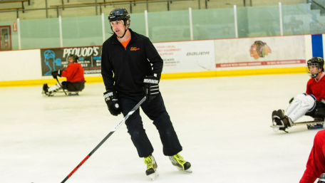 derek Daniels playing hockey with the adaptive hockey team