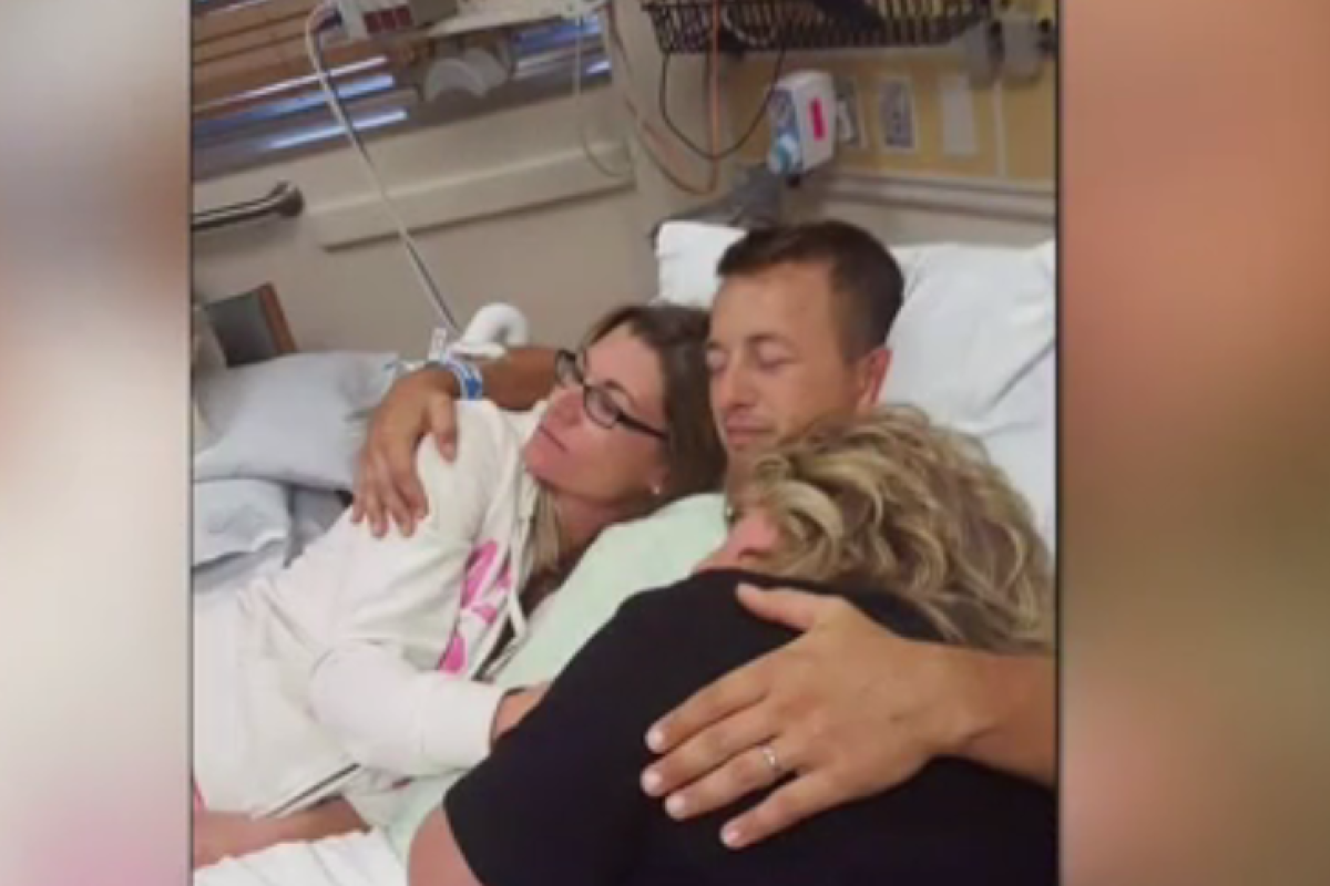 Cole hugs his family while recovering from the SCI