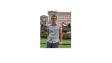 young man in front of European buildings