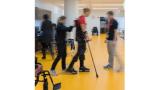 a blurred photo of a patient being helped to talk by a rehabilitation therapist