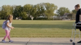 Evelyn walking towards her daughter