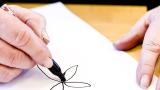 An MS patient works on their fine motor skills by drawing a flower